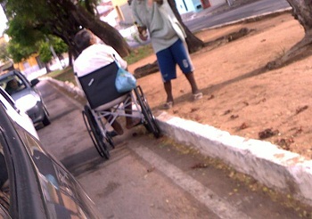 Homem com paraplegia mendigando