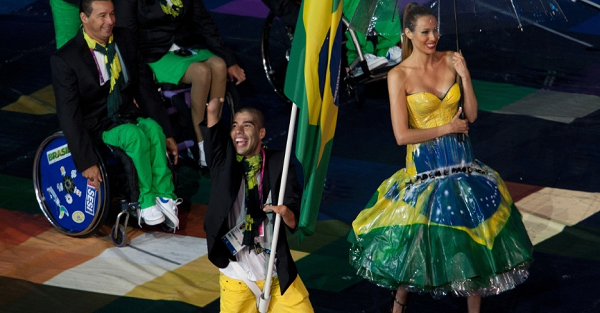 Cadeirantes carregam bandeira do Comitê Paraolímpico durante cerimônia de abertura dos Jogos